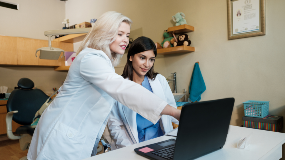 dentists looking at dental software